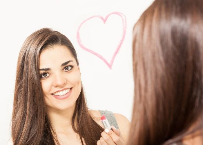 happy woman looking at the mirror