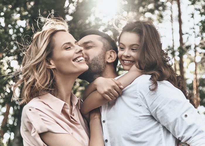 man with wife and daughter on the forest walk