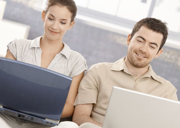 couple with laptops