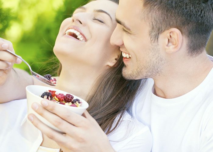 happy couple eats granola