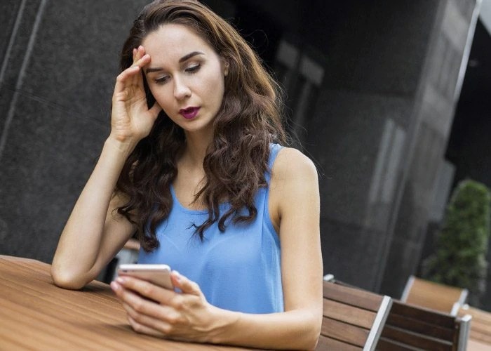 woman in blue dress with phone