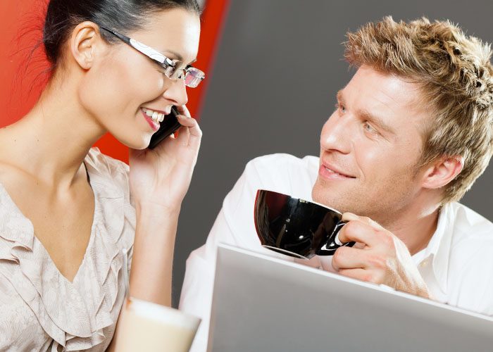couple with laptop and phoe drinks coffee