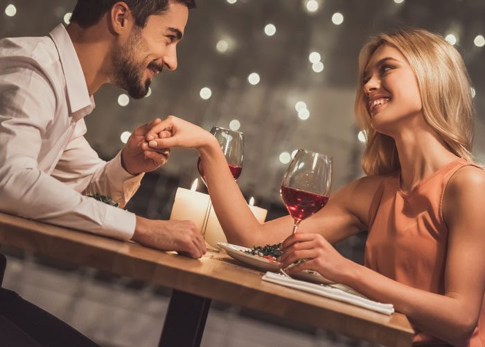 couple drinks wine on a date in the restaurant