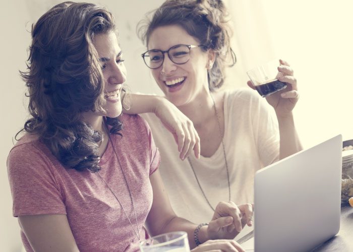 two woman with laptop