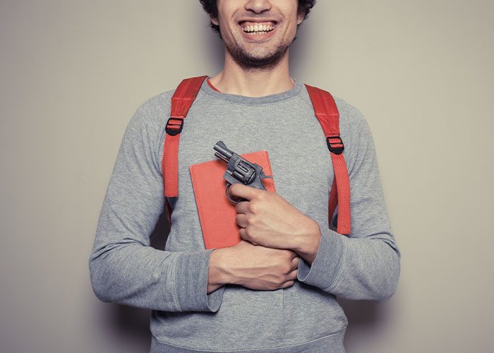 smiling man with gun